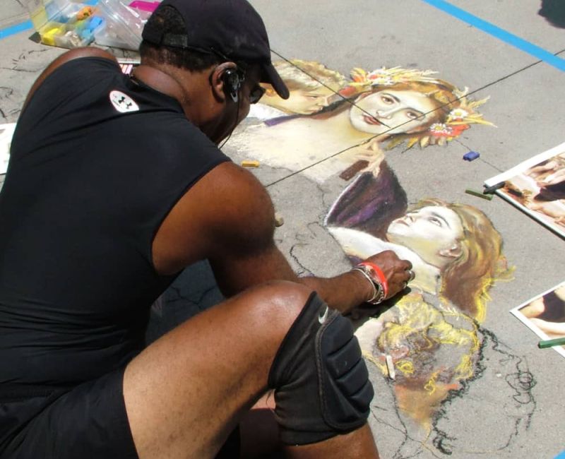 Man creating sidewalk chalk art