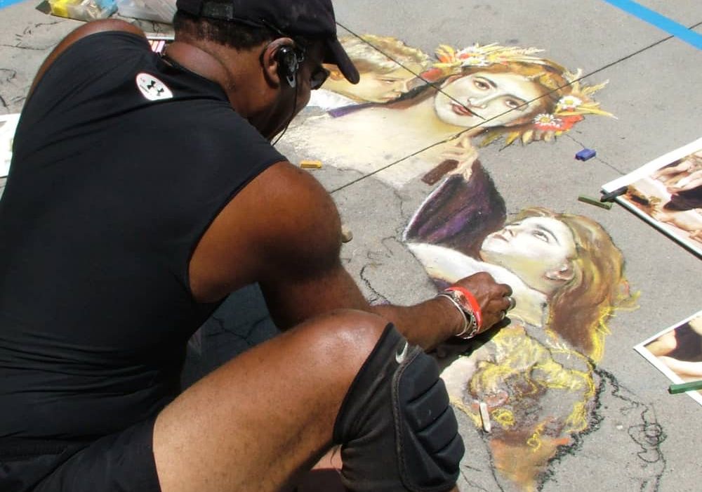 Man creating sidewalk chalk art